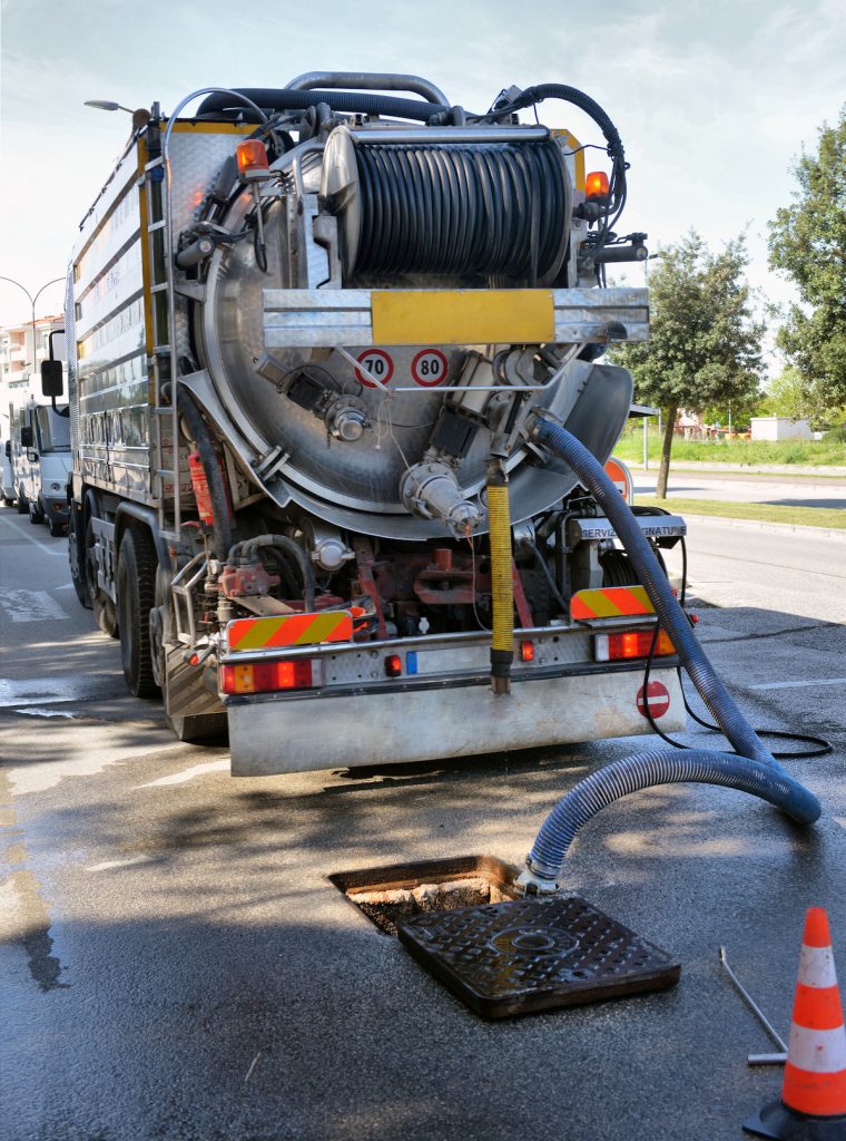 cleaning truck pumps out the water drain